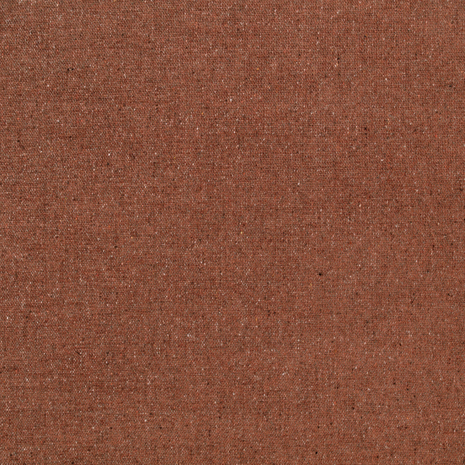 Close-up of rust terracotta woven fabric with fine pale flecks and subtle texture
