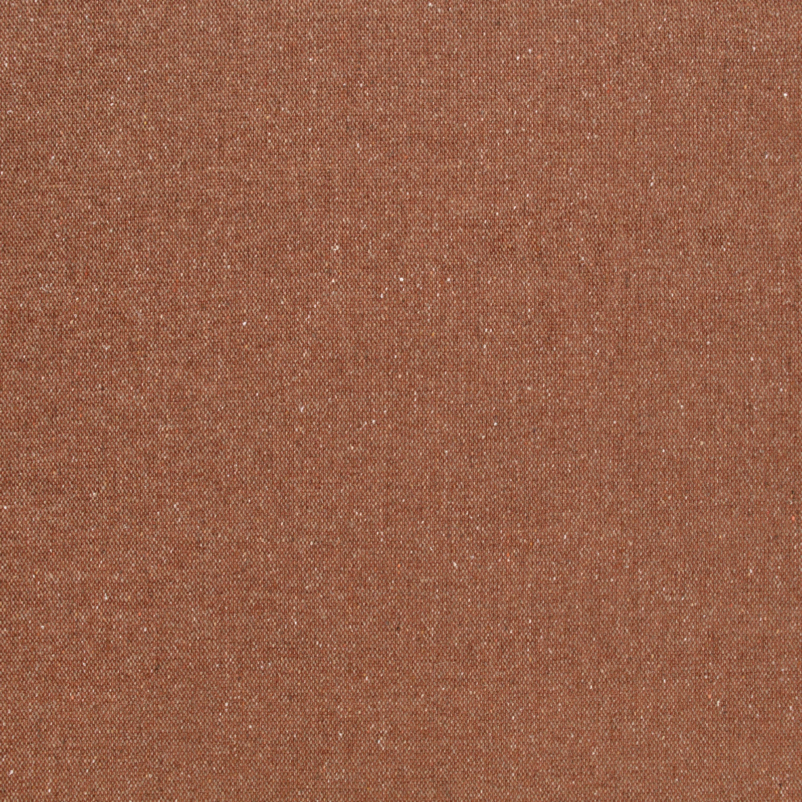 Close-up of warm terracotta fabric with fine pale flecks and a tight woven texture