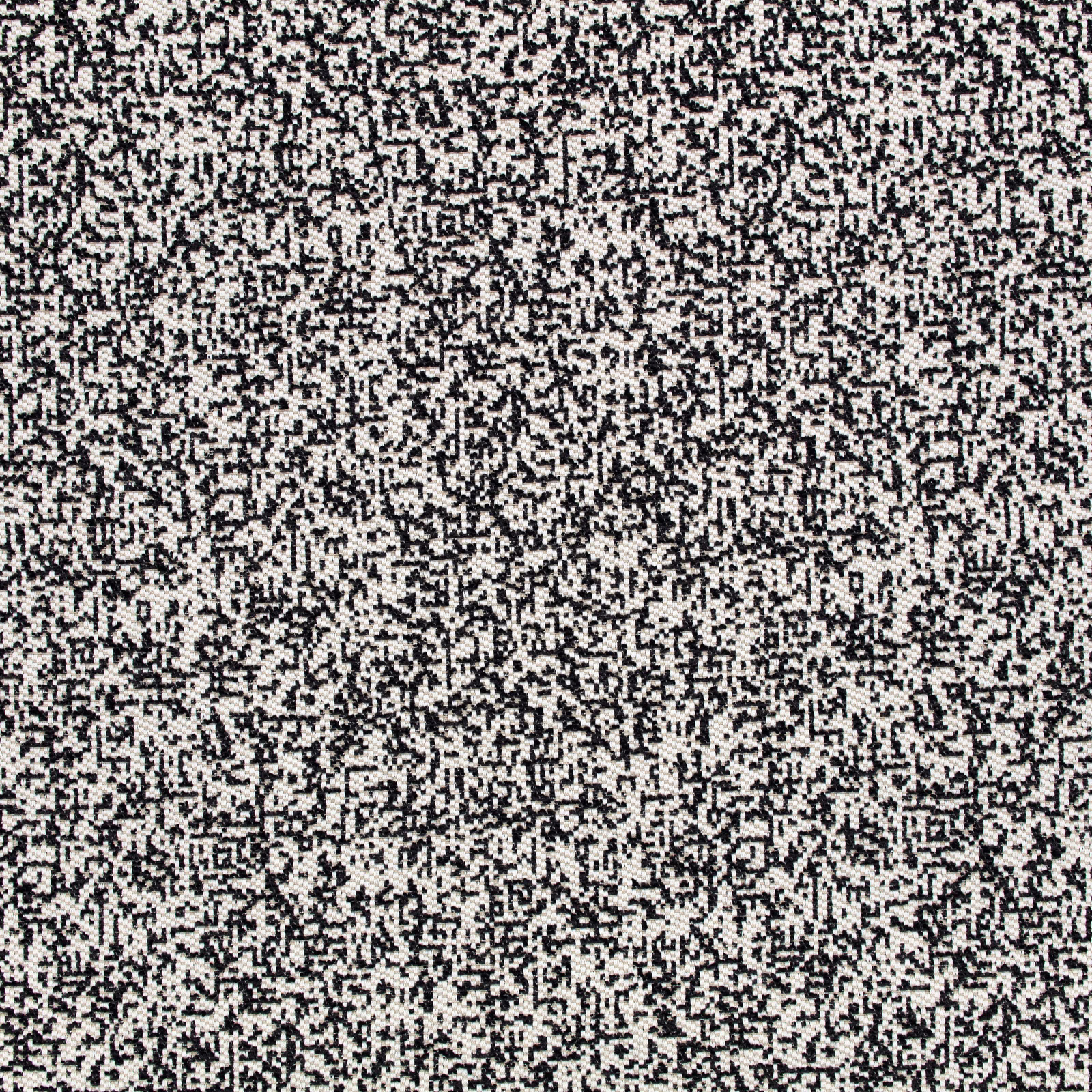 Close-up of ivory fabric with dense black pixel-like woven marks
