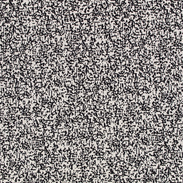 Close-up of ivory fabric with dense black pixel-like woven marks