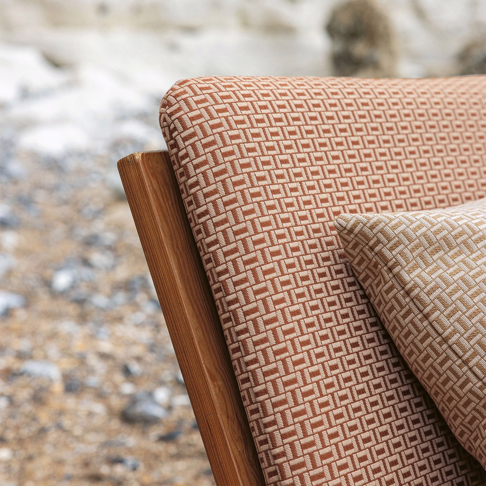 Burnt orange and cream geometric woven fabric covering a wooden chair and cushion