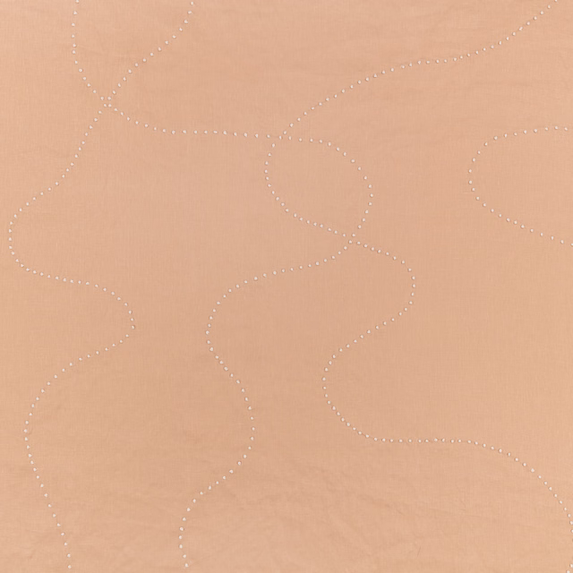 Warm clay fabric with pale dotted, looping lines and a softly matte surface