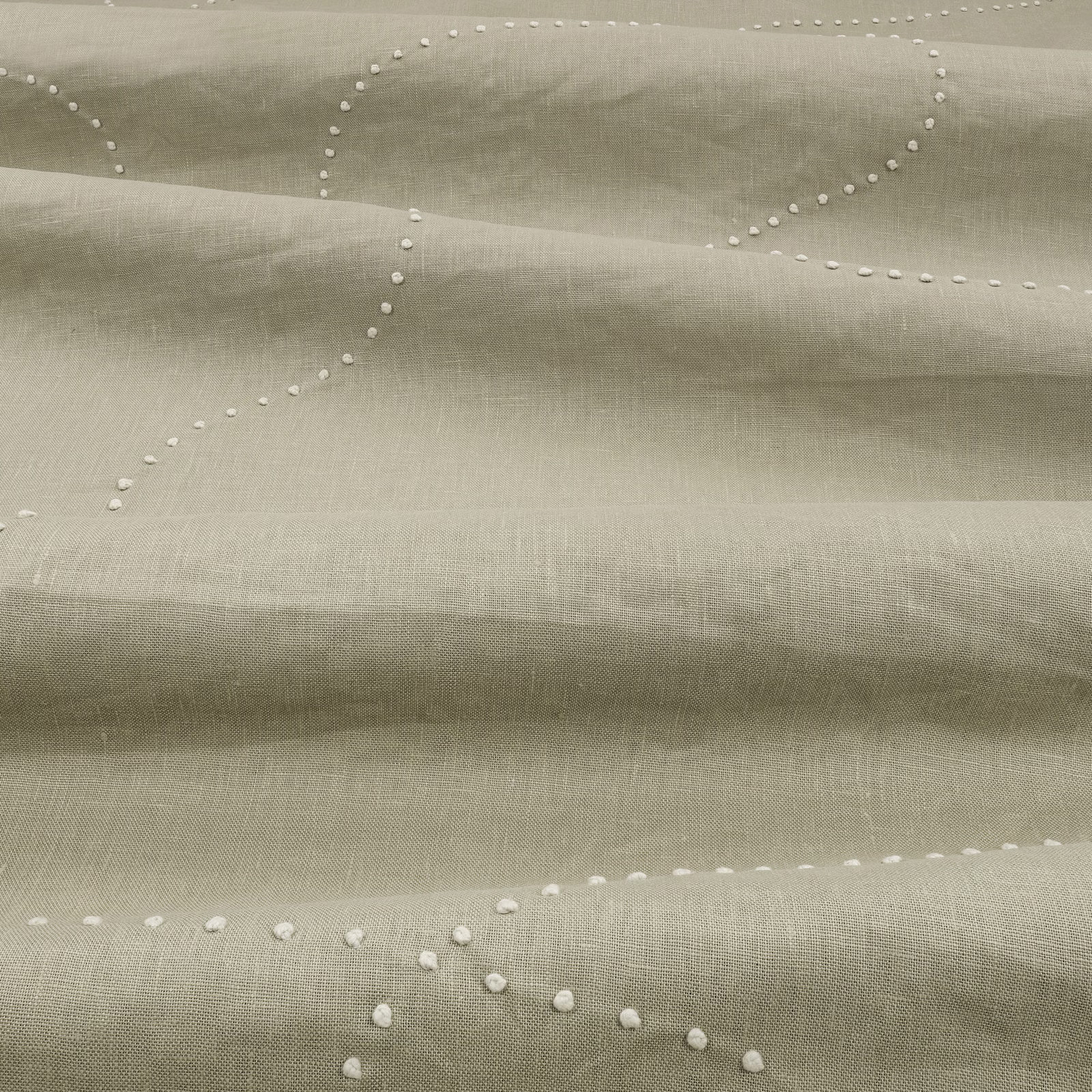 Pale sage-green woven fabric with raised white dotted looping lines