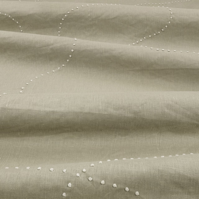 Pale sage-green woven fabric with raised white dotted looping lines