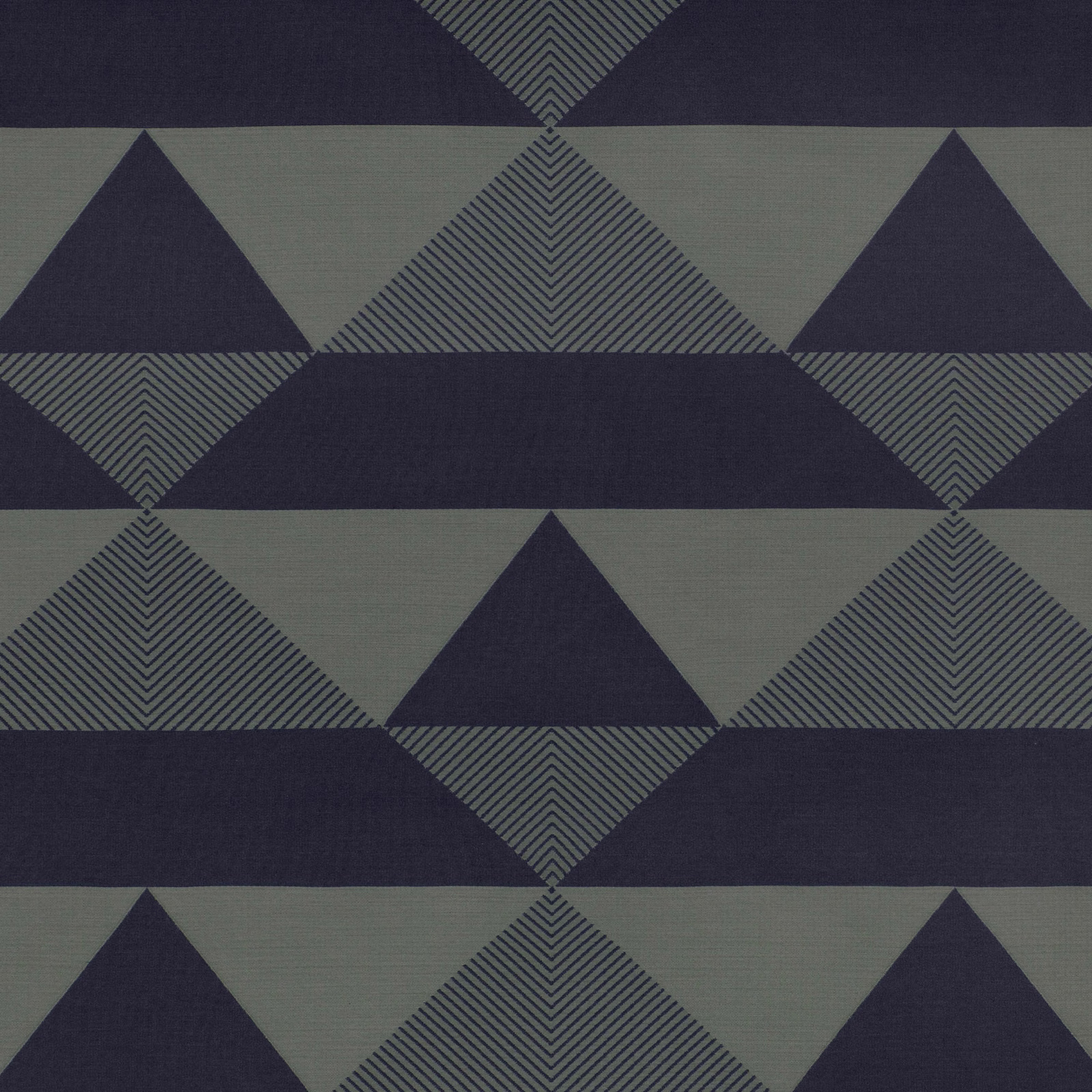Deep navy and grey-green geometric triangles with chevron-filled diamonds in a woven textile