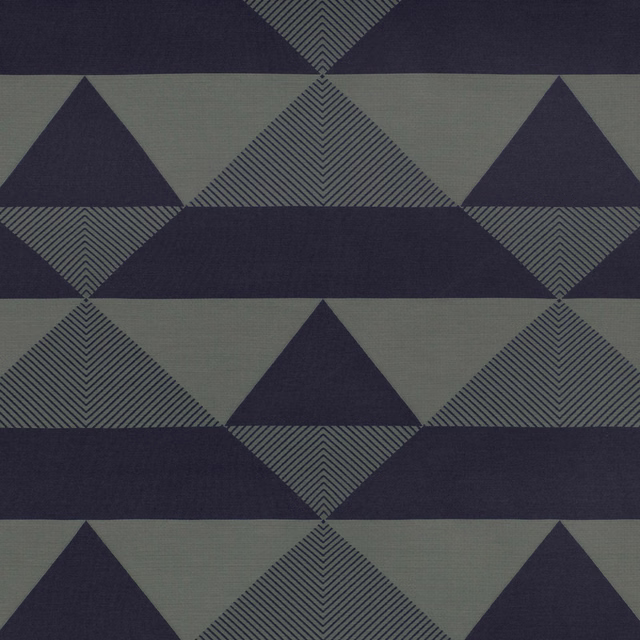 Deep navy and grey-green geometric triangles with chevron-filled diamonds in a woven textile