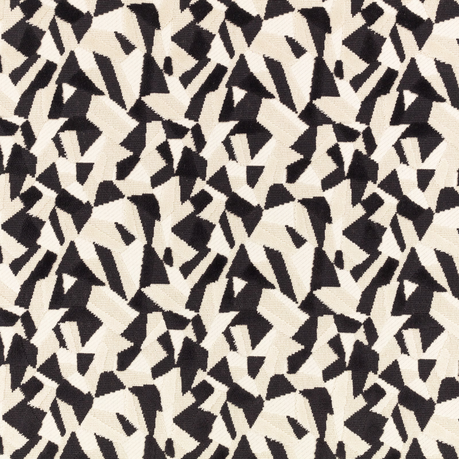 Black and ivory woven fabric with dense abstract angular shapes and tactile textured surface