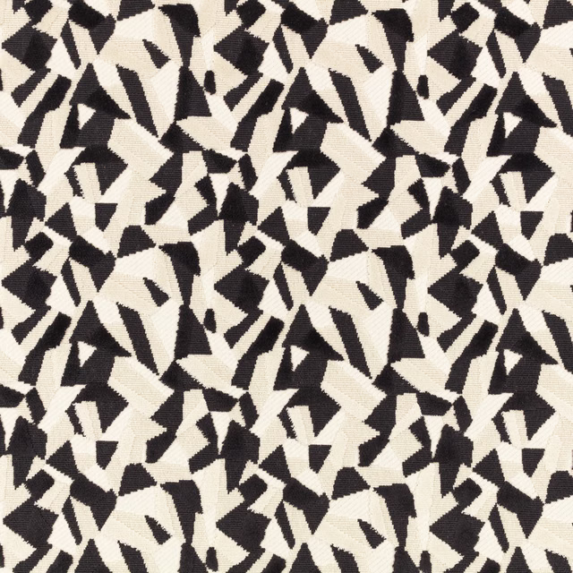 Black and ivory woven fabric with dense abstract angular shapes and tactile textured surface
