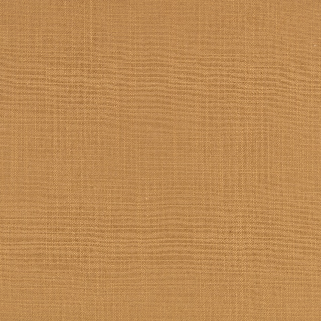 Close-up of warm golden ochre fabric with a fine, even woven texture