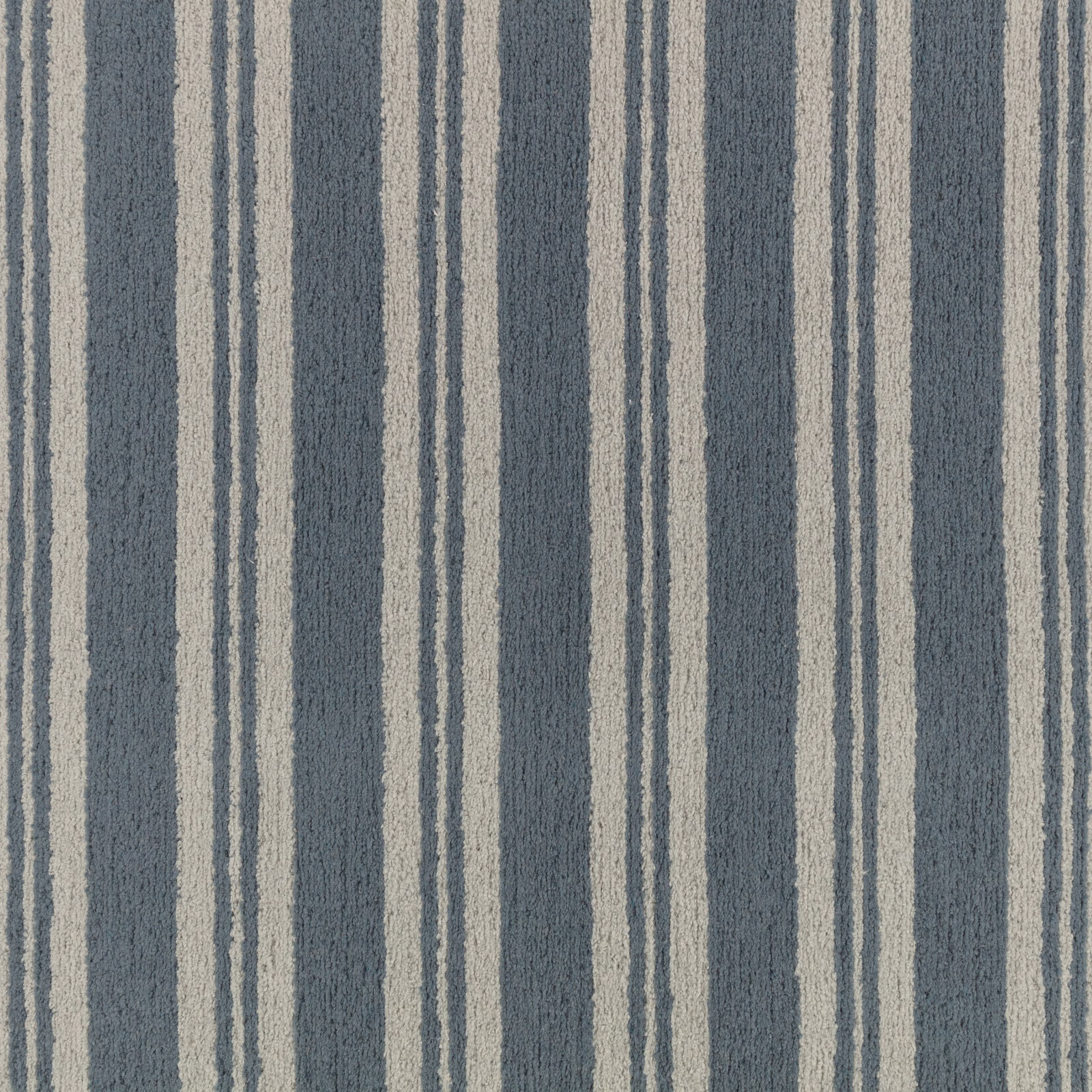 Muted denim-blue fabric with irregular pale vertical stripes and a softly nubby woven texture