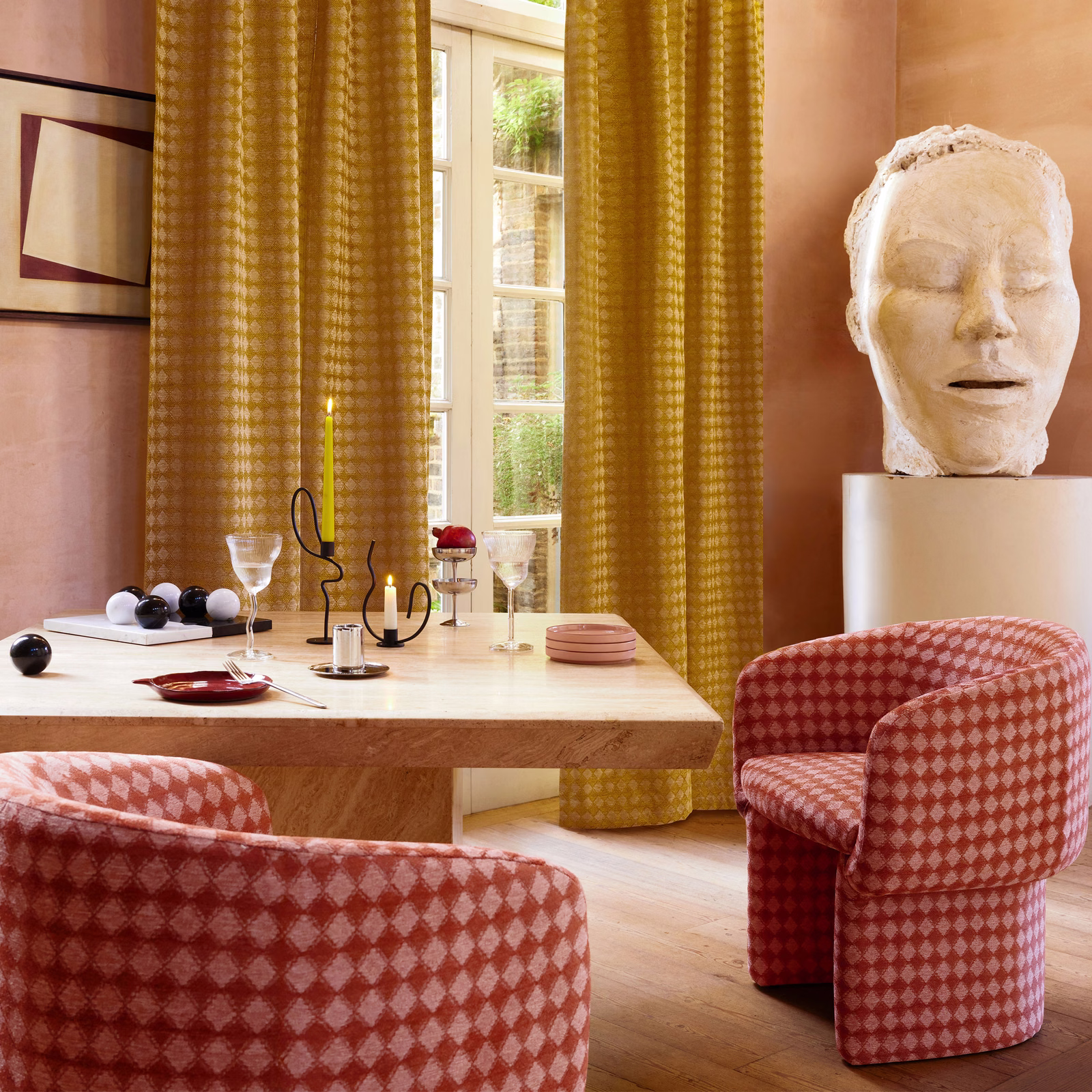 Dusty coral and blush diamond-check upholstery on rounded chairs