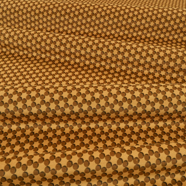 Warm tobacco woven fabric with dense dark brown circular dot pattern and tactile surface