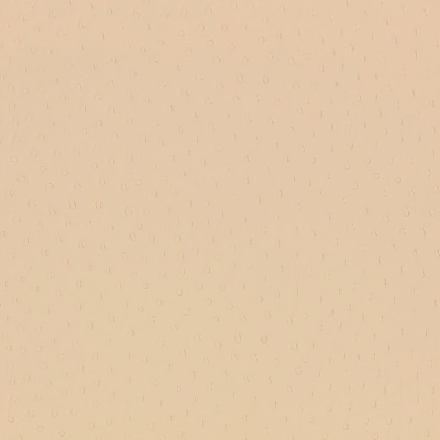 Pale nougat leather-look surface with tiny, low-contrast ostrich-like marks