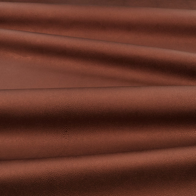 Warm russet-brown pebbled surface showing fine shagreen grain across soft layered folds