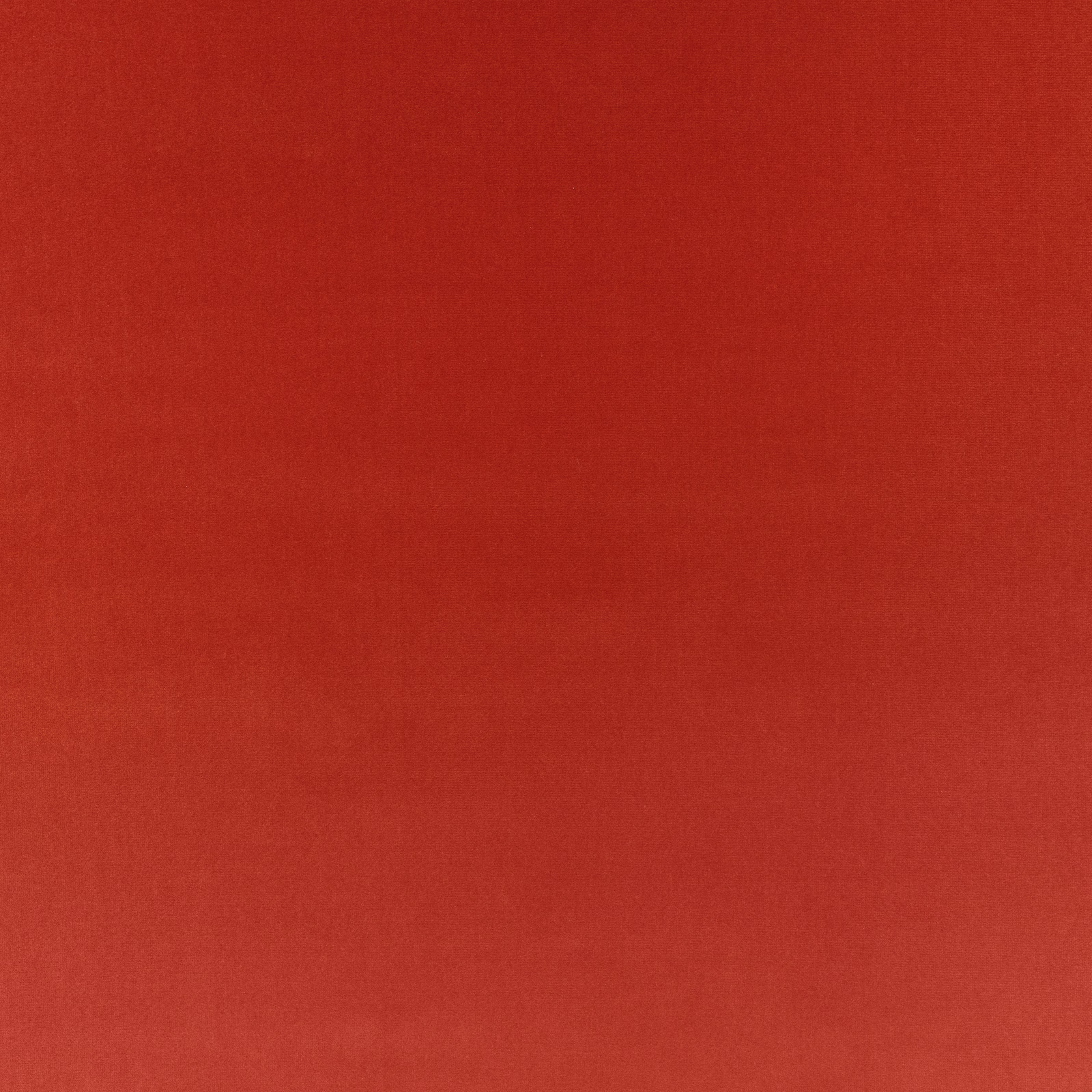 Close-up of warm cayenne-red plain weave with subtle tonal texture