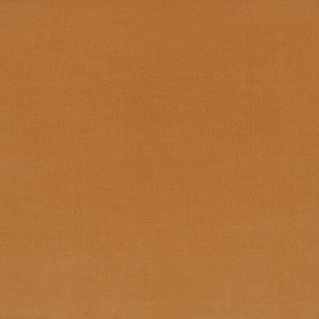Close-up of plain warm Havana orange textile with subtle tonal surface texture