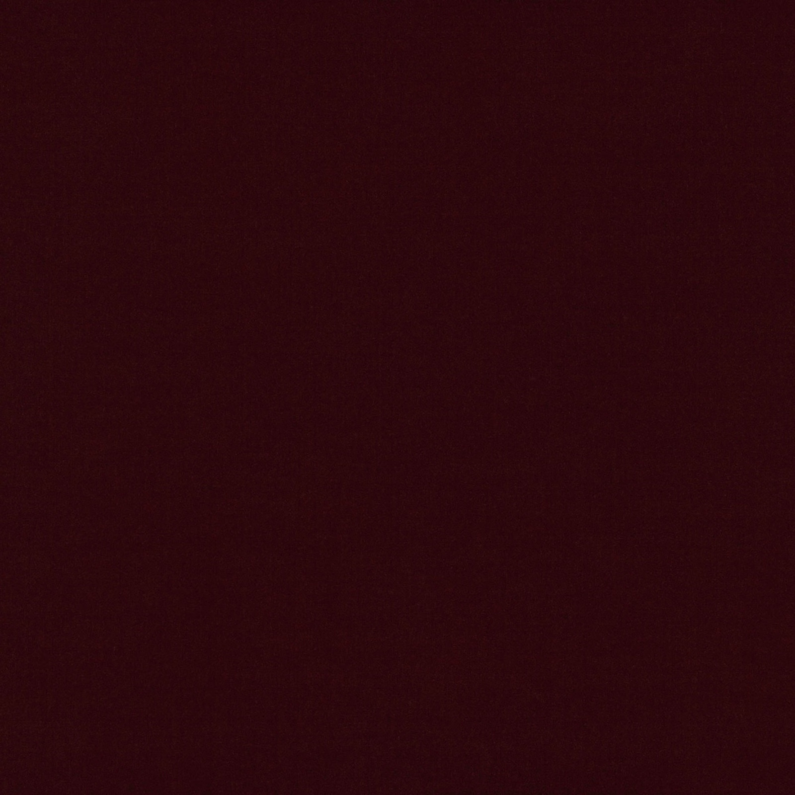 Deep ruby burgundy fabric with a subtle, dense plain weave and softly mottled surface