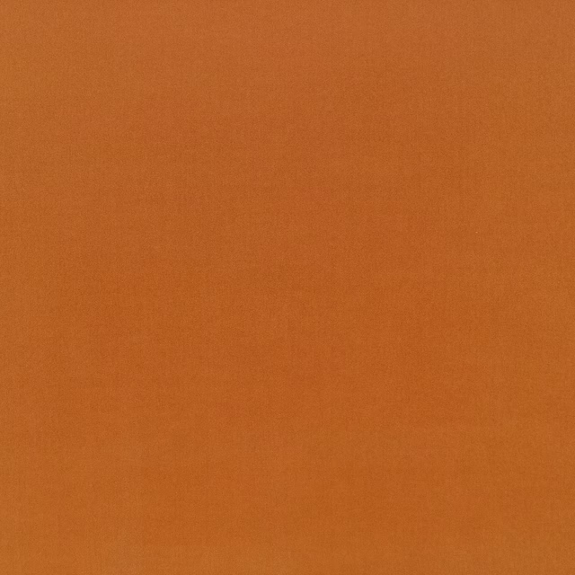 Close-up of warm tangerine-orange fabric with a fine, subtly textured plain weave