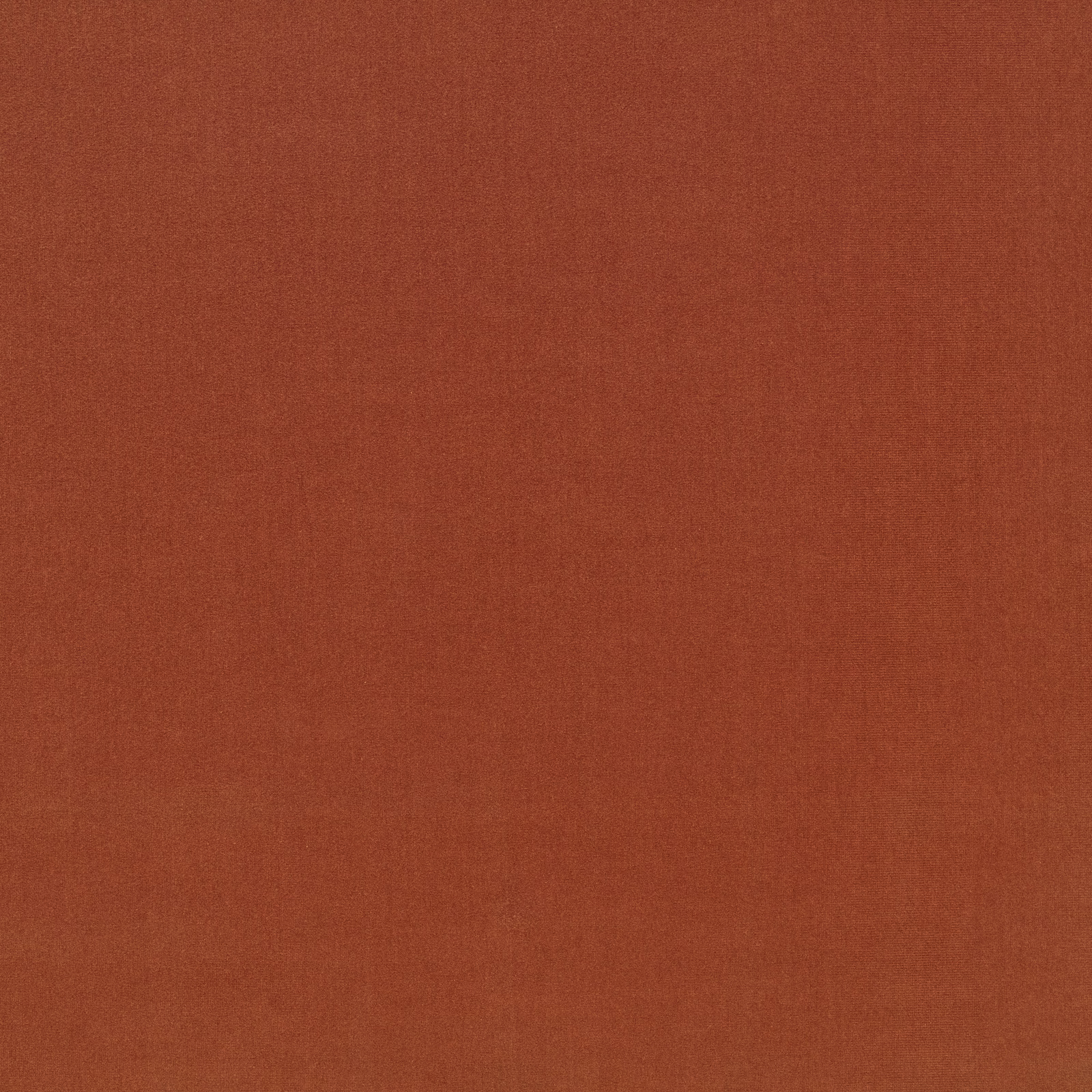 Close view of muted burnt terracotta cloth with a fine, softly textured weave