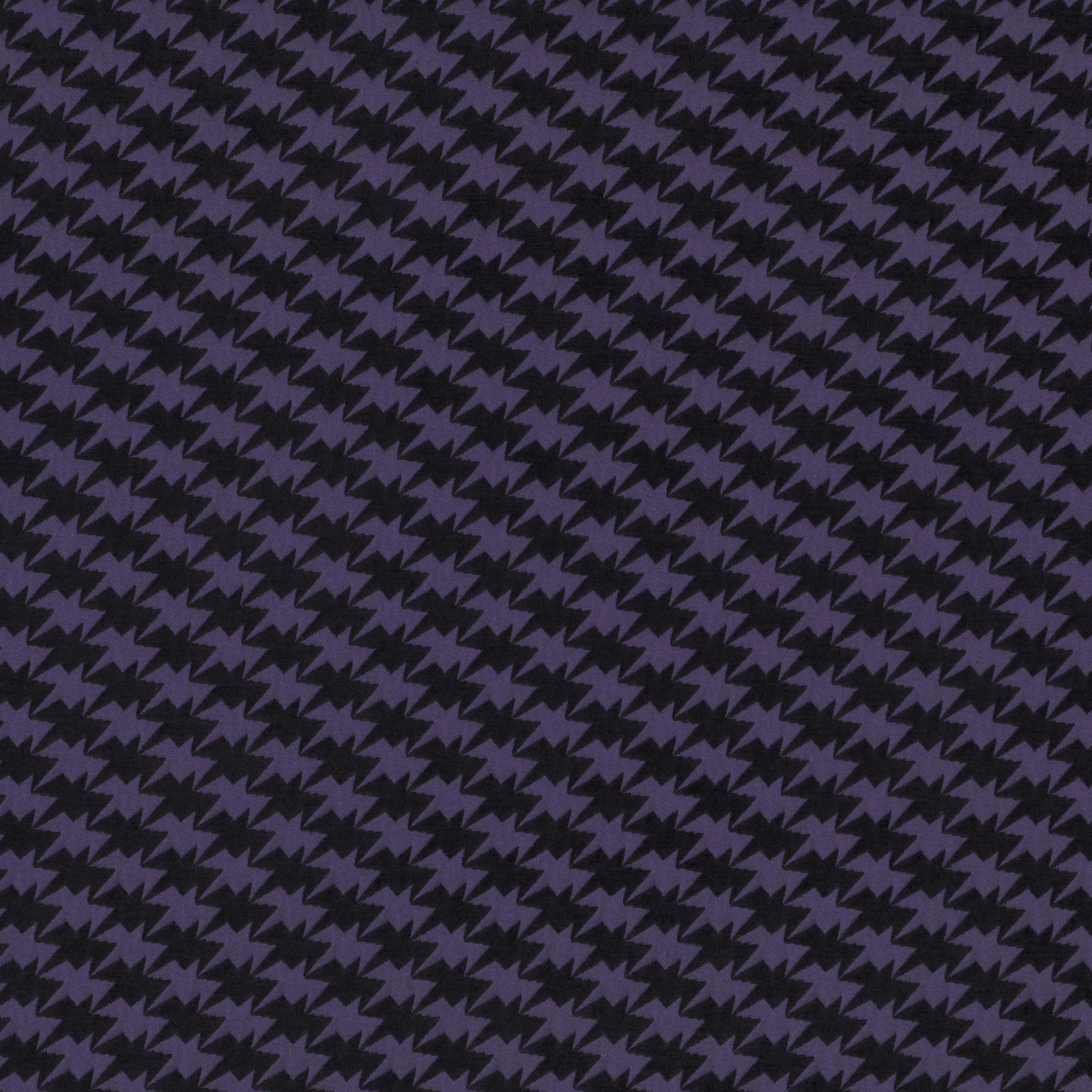 Close-up of midnight purple and black zig-zag bird motifs in a fine textured weave