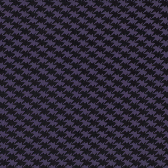 Close-up of midnight purple and black zig-zag bird motifs in a fine textured weave