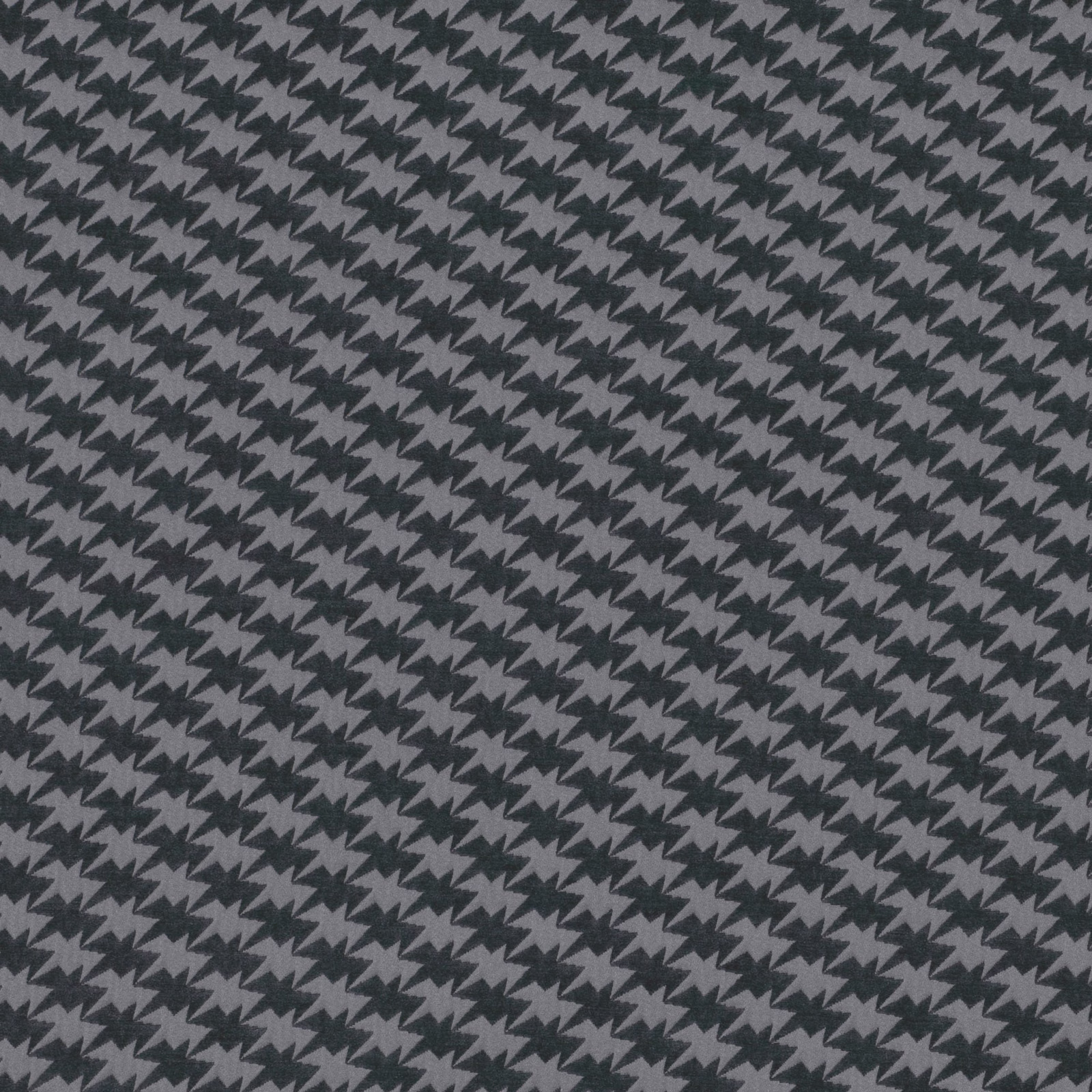 Close view of charcoal and slate-grey woven zigzag birds in a dense repeat