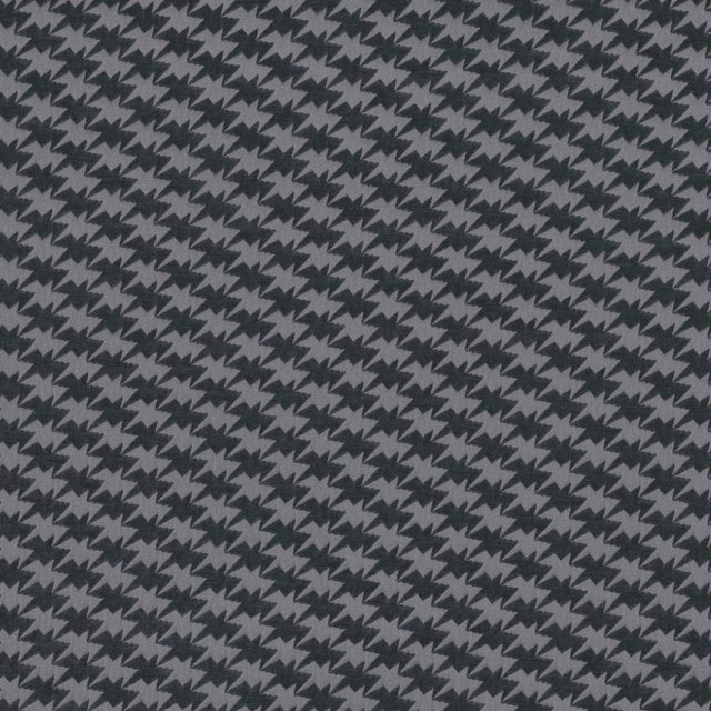 Close view of charcoal and slate-grey woven zigzag birds in a dense repeat
