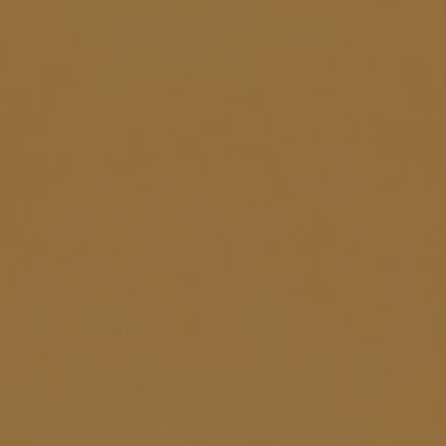 Close view of a plain golden ochre textile with a soft, even surface
