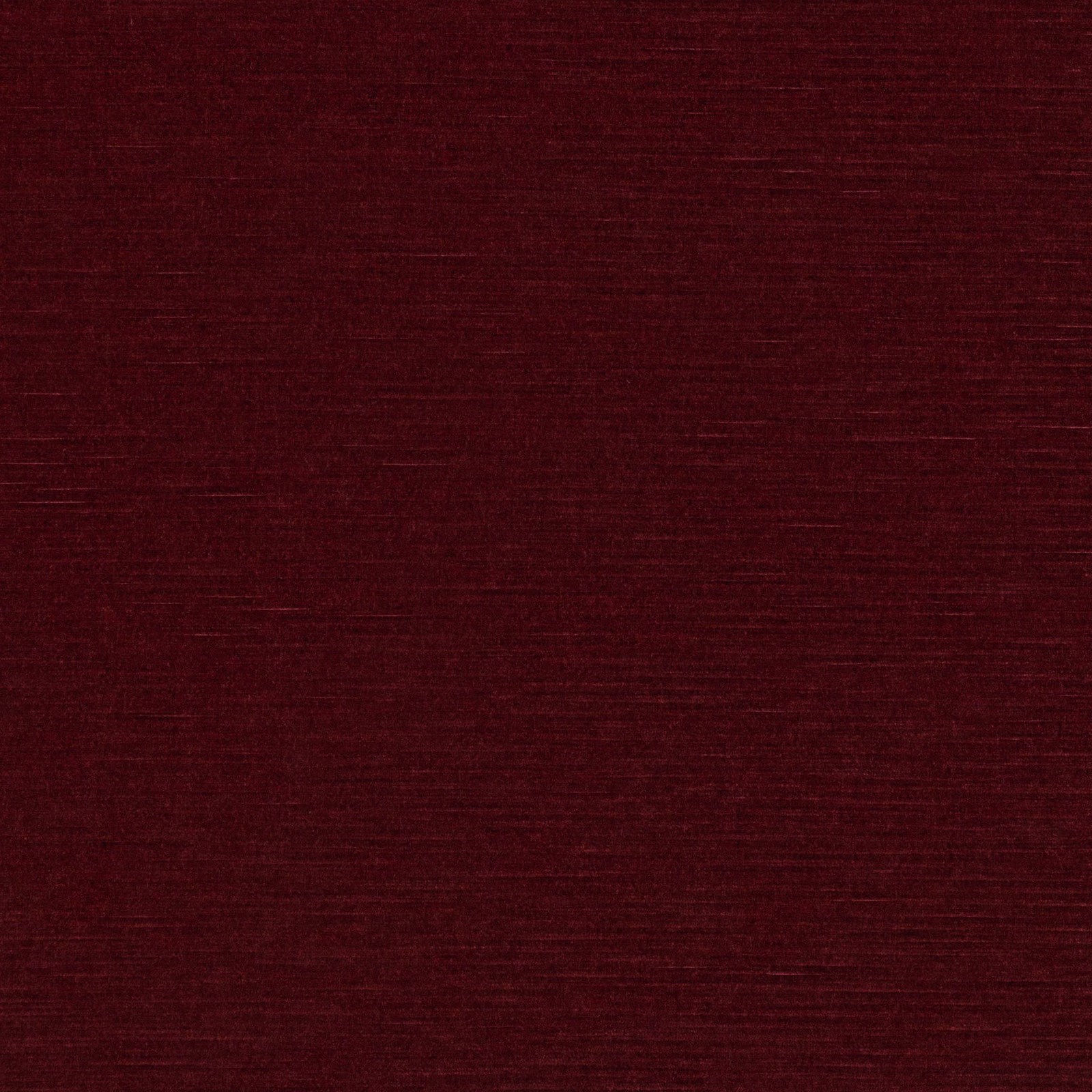 Deep ruby-red textile with fine horizontal slub lines and a dense woven surface