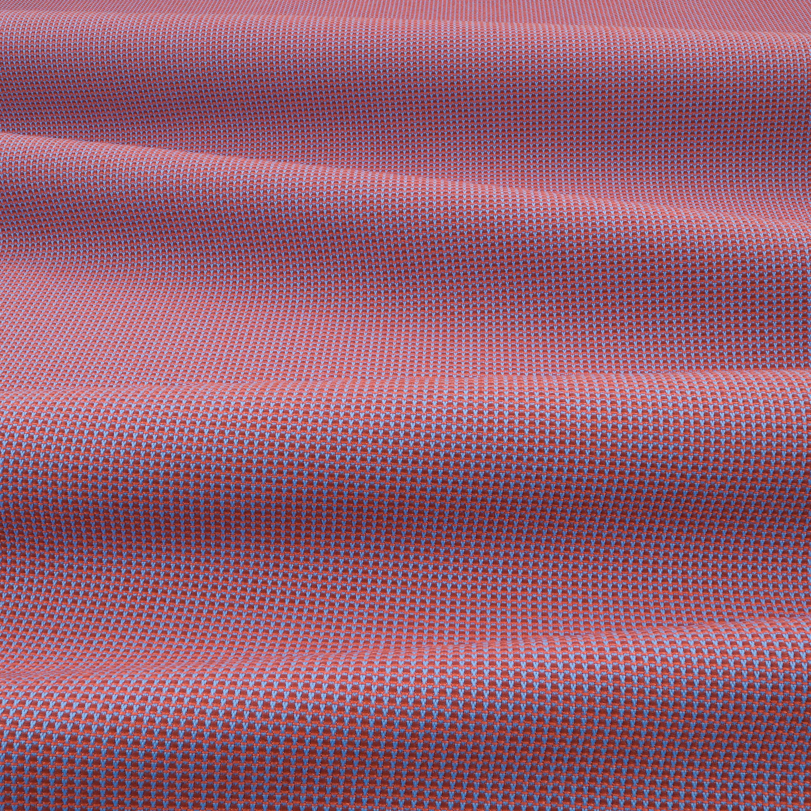 Close-up of pomegranate pink outdoor weave with blue-grey flecking and raised folds