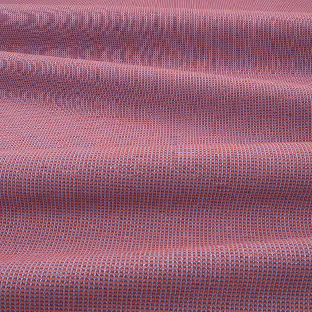 Close-up of pomegranate pink outdoor weave with blue-grey flecking and raised folds