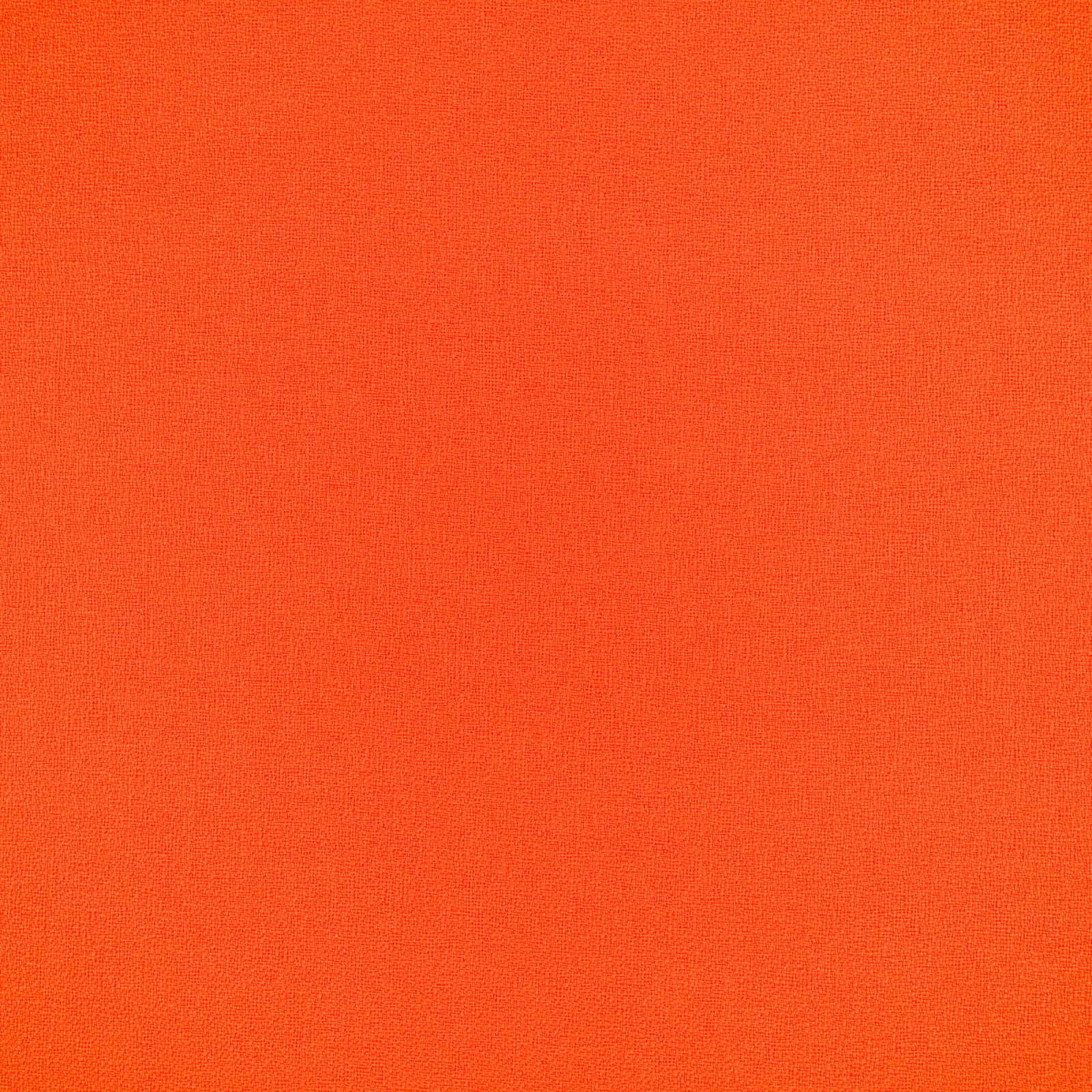 Close-up of finely woven saturated blood orange outdoor upholstery fabric
