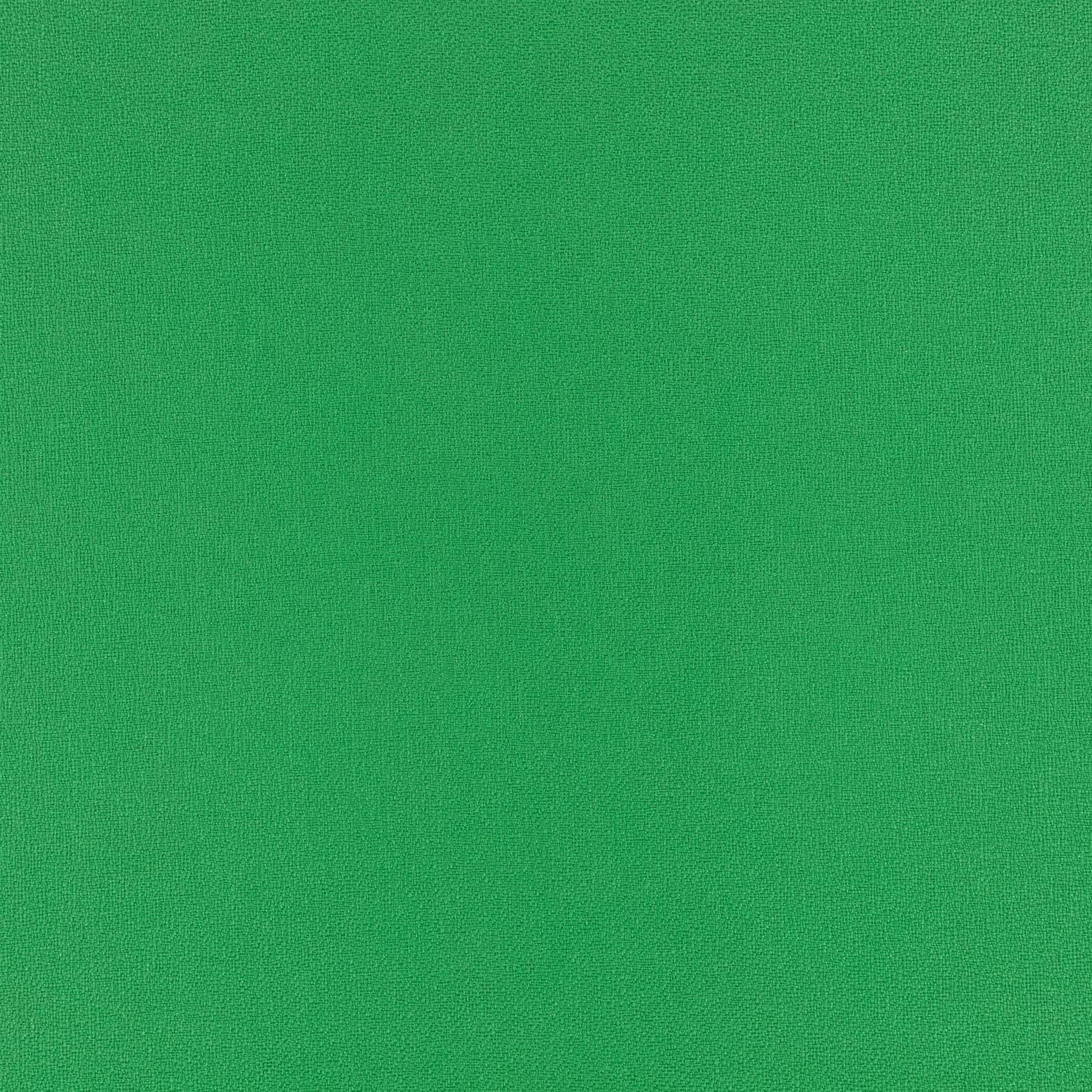 Close-up of vivid salad-green fabric with a fine, even woven texture