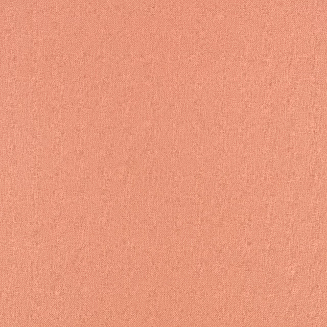 Close-up of coral-peach Sol Macaron fabric with a fine, even woven texture