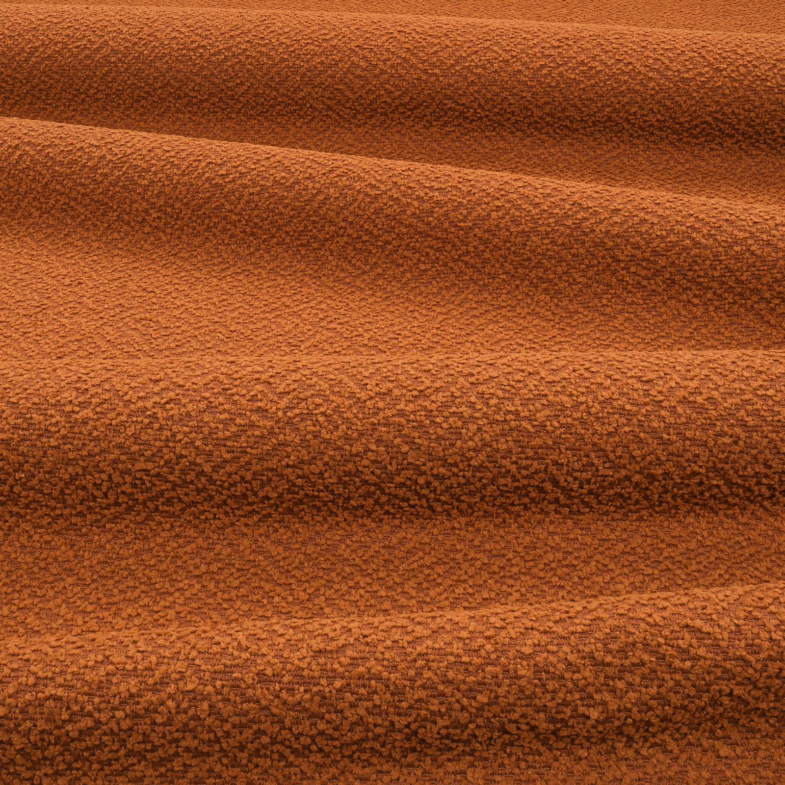 Burnt terracotta outdoor fabric with dense nubby texture and horizontal shadowed folds