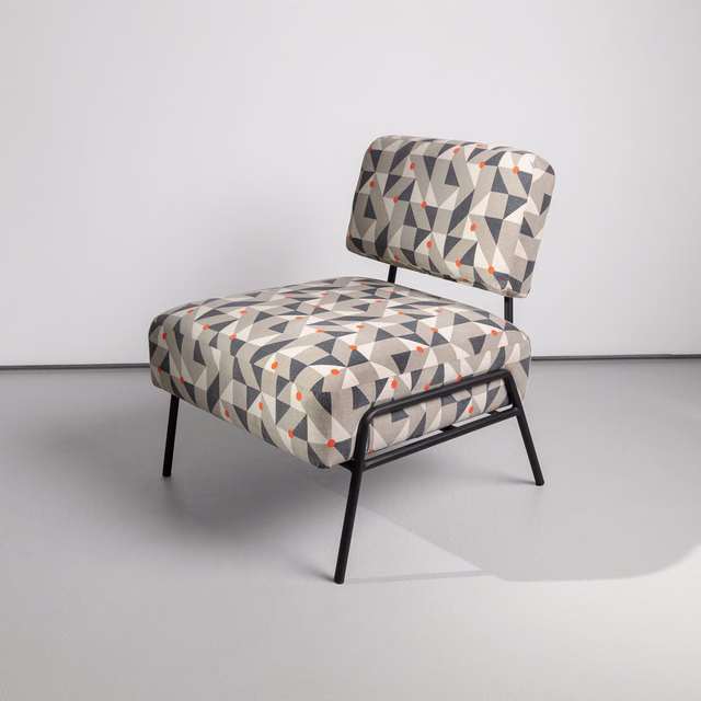 Burnt-orange, cream, grey and charcoal geometric upholstery on a modern lounge chair