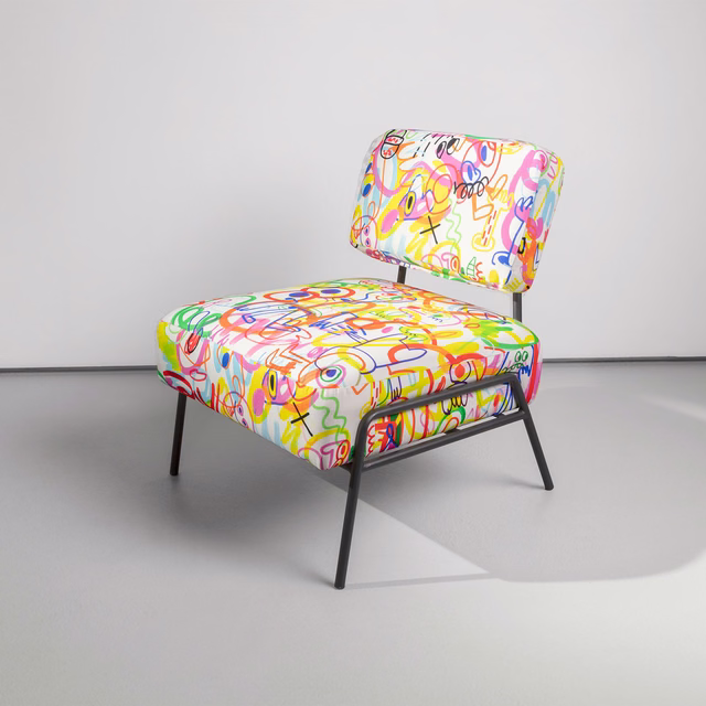 White chair covered in bright multicolour abstract scribble fabric