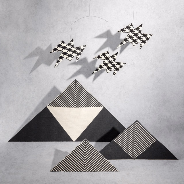 Black-and-white zigzag birds above bold chevron and triangular motifs