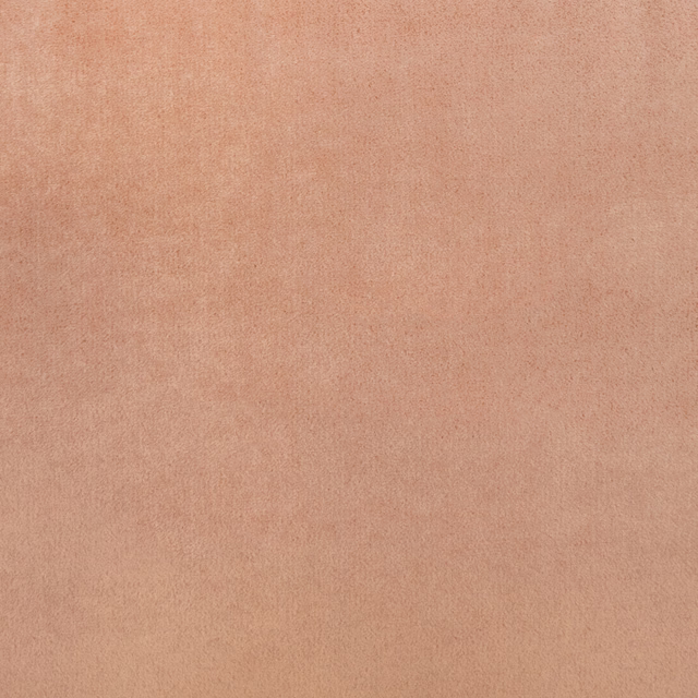 Dusty amber-peach plain fabric with softly mottled, suede-like surface texture