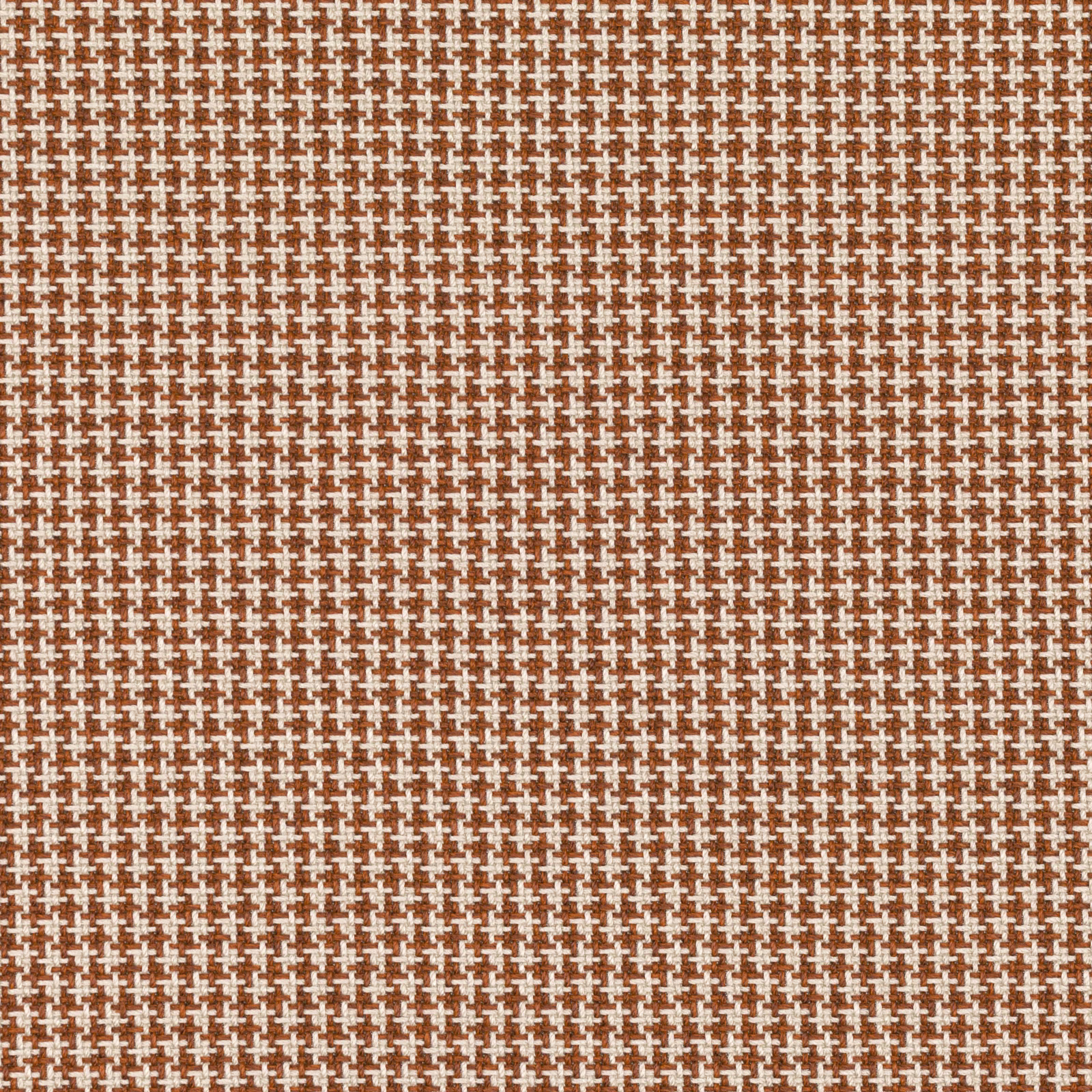 Burnt-orange woven fabric with tiny cream cross motifs and a tactile textured surface