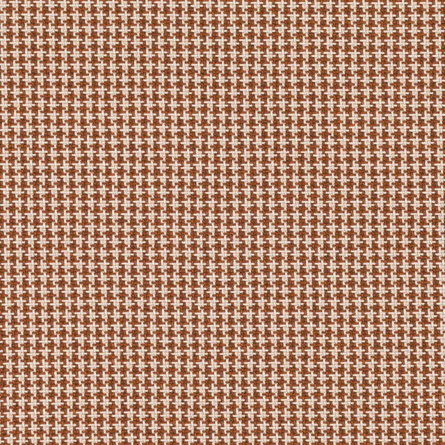 Burnt-orange woven fabric with tiny cream cross motifs and a tactile textured surface