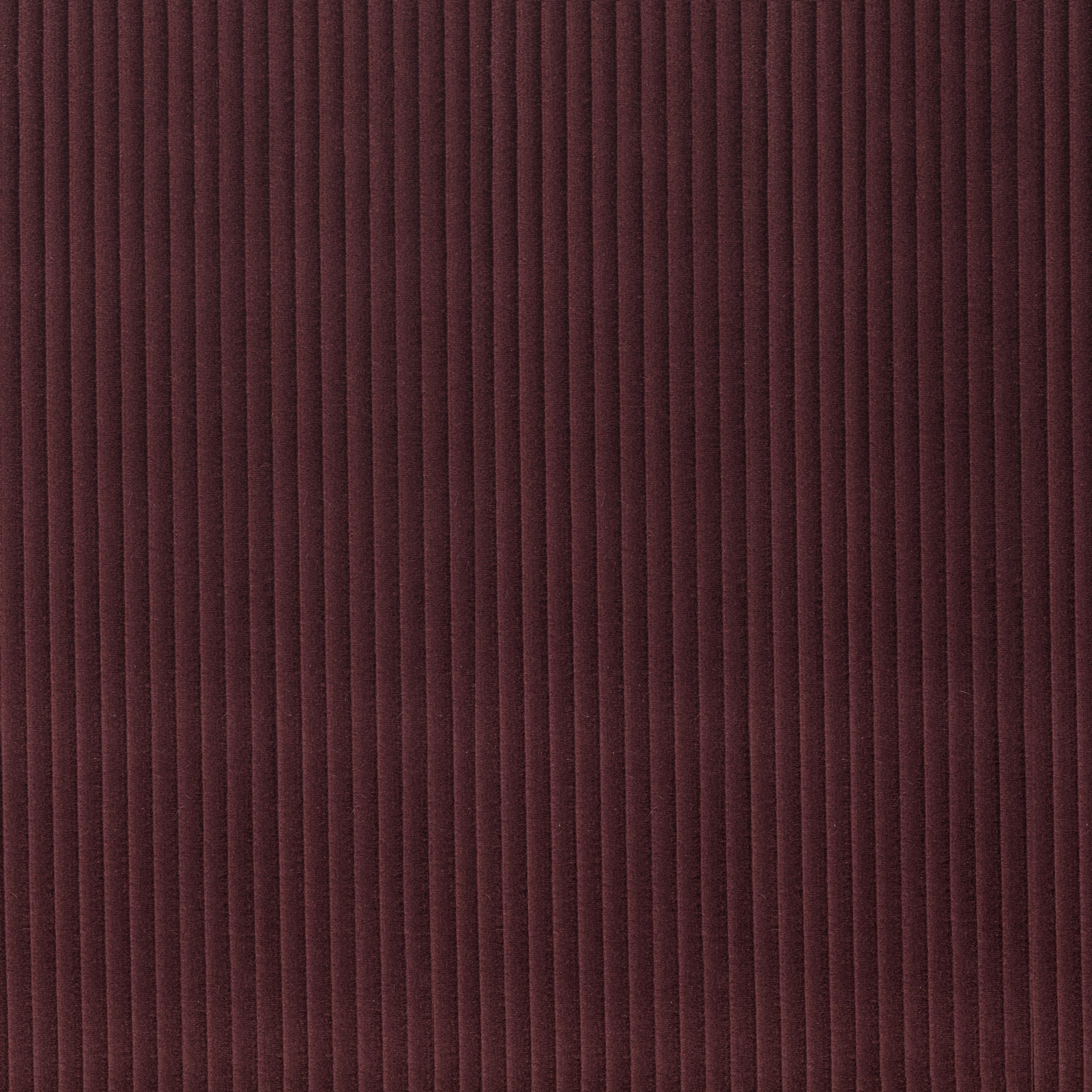 Deep aubergine ribbed textile with narrow vertical channels and softly shaded texture