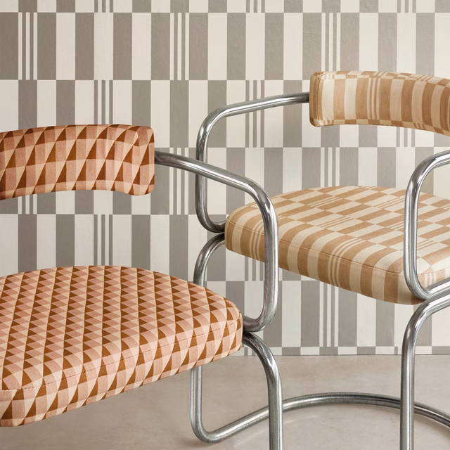 Warm oat-beige geometric upholstery with camel bands on a curved armchair