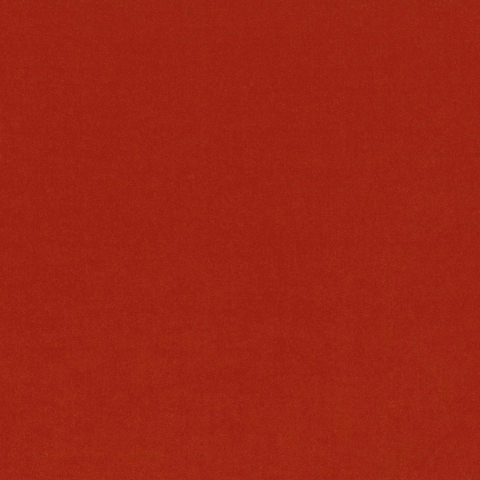 Close-up of Smooth Fire fabric in a warm, subtly mottled flame red