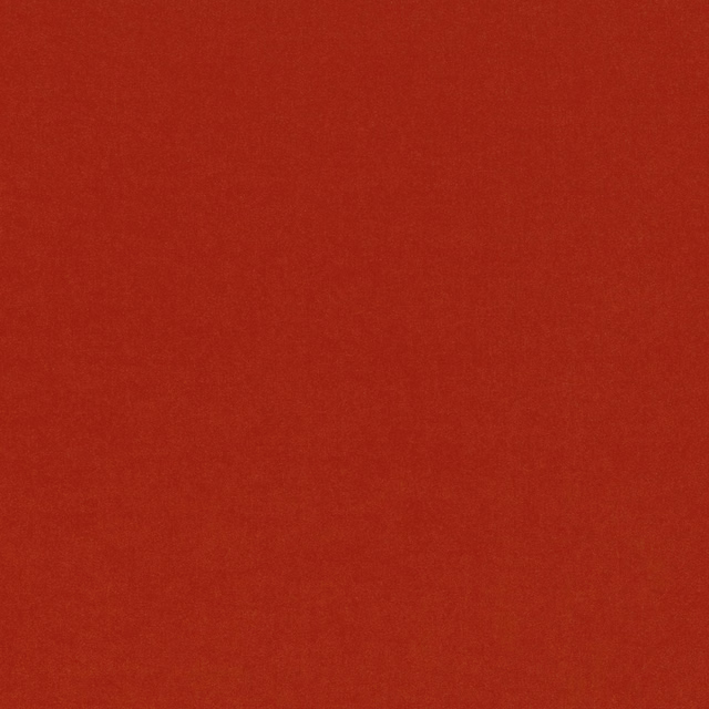 Close-up of Smooth Fire fabric in a warm, subtly mottled flame red