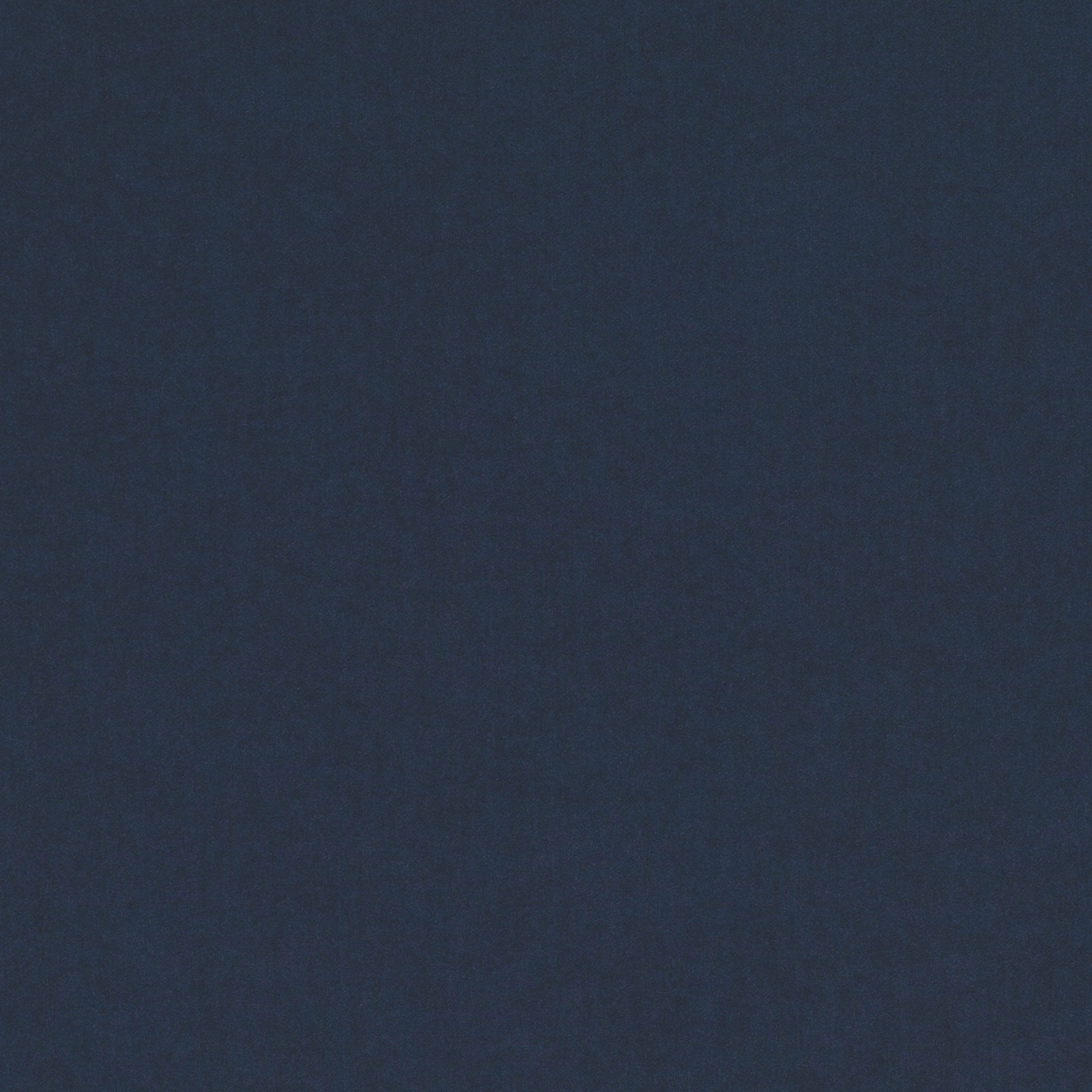 Close-up of smooth deep indigo blue fabric with subtle tonal texture