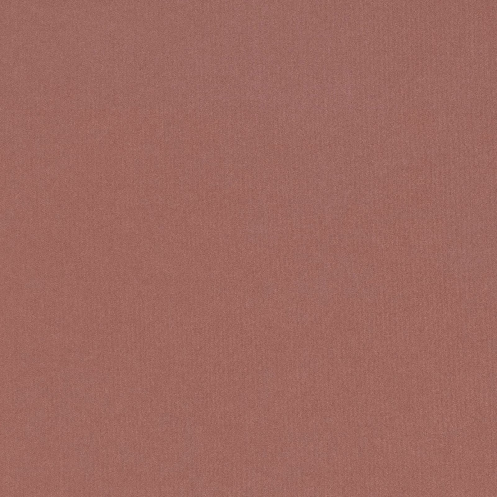 Close view of muted terracotta-rose plain fabric with a fine, soft texture