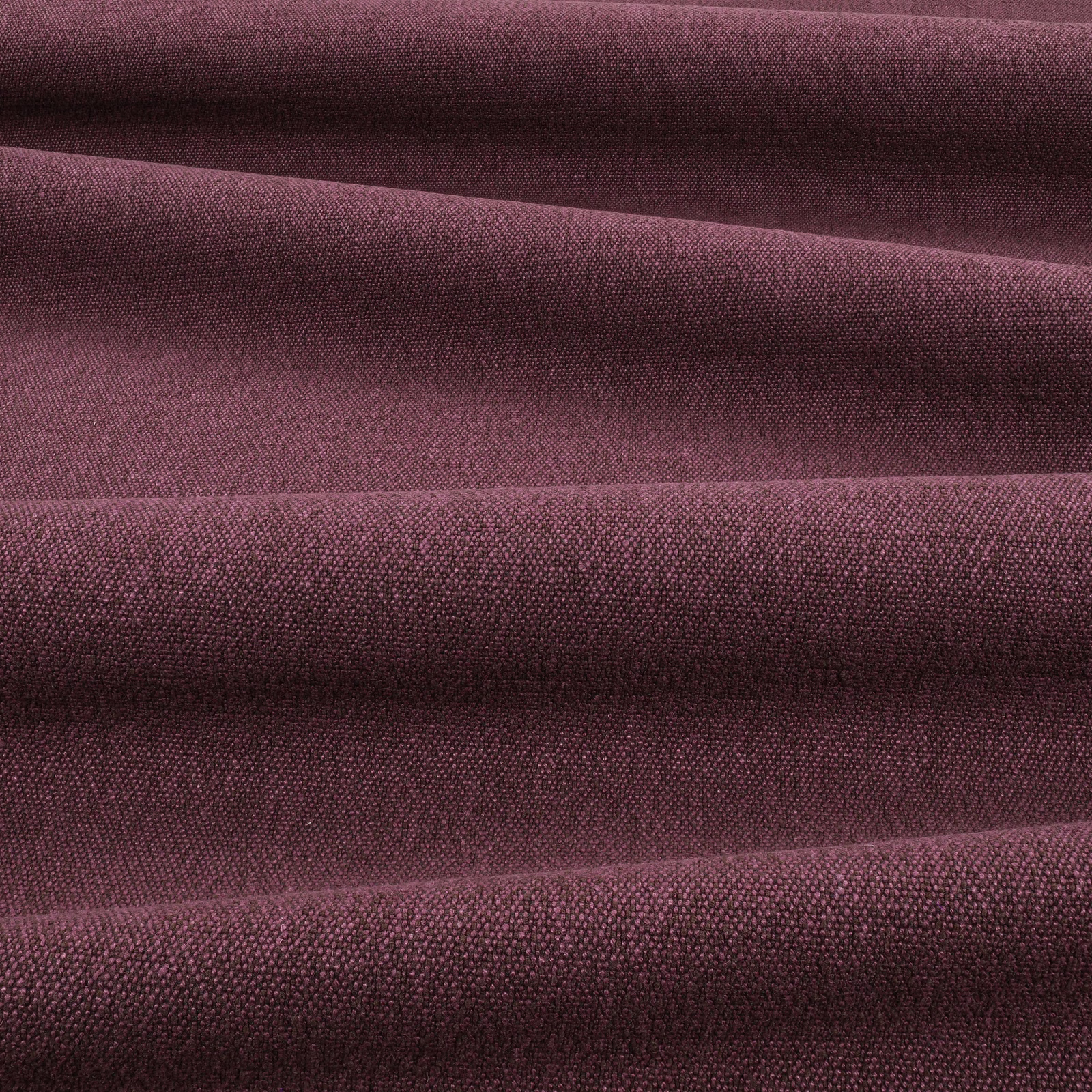 Deep fig-plum woven fabric folded to reveal a fine, tactile surface