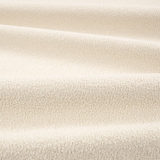 Warm ivory teddy-textured fabric with dense nubby pile and softly mottled shading