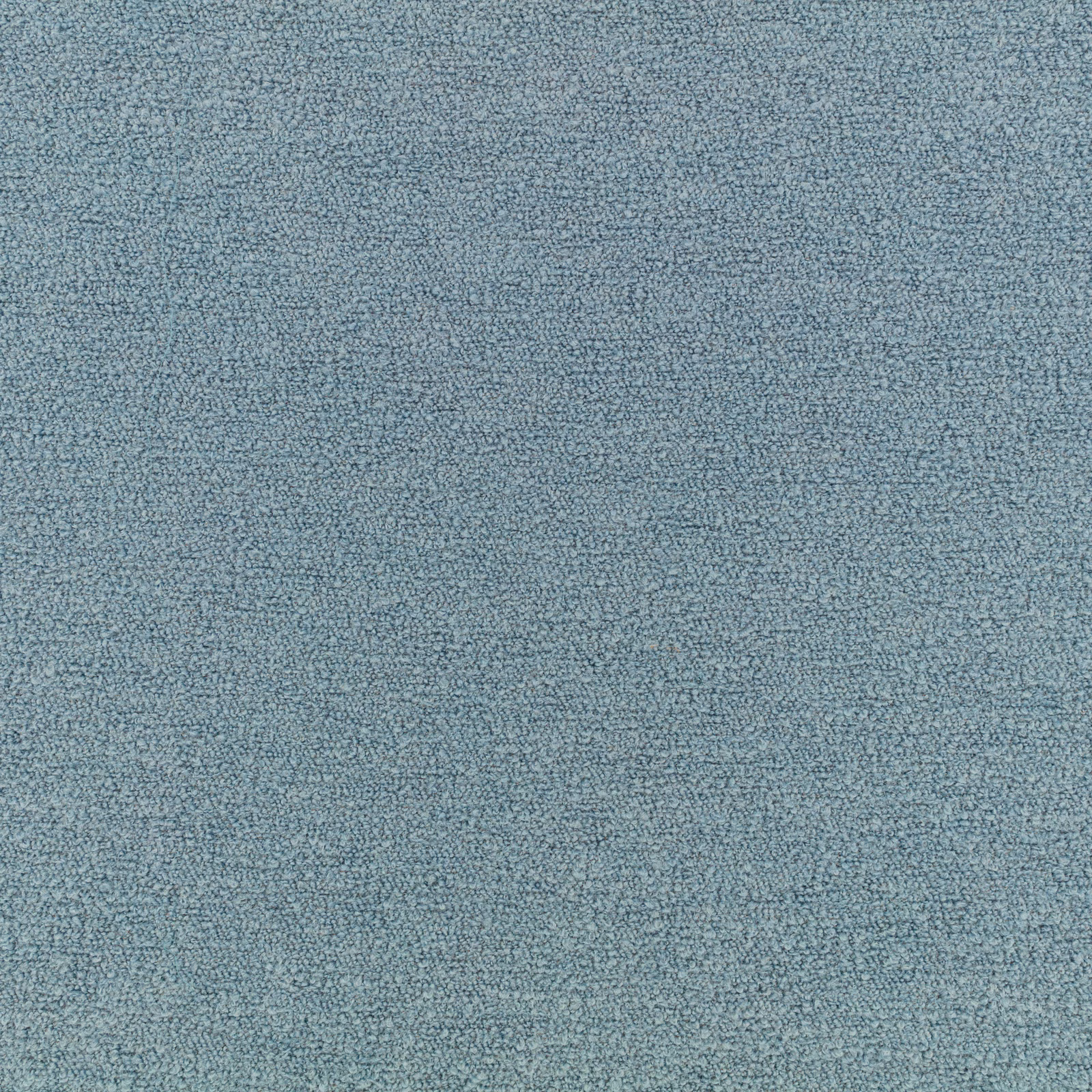 Close-up of muted ocean-blue fabric with a fine, softly mottled nubby weave